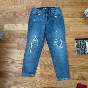 straight-leg blue jeans with a distressed ripped look